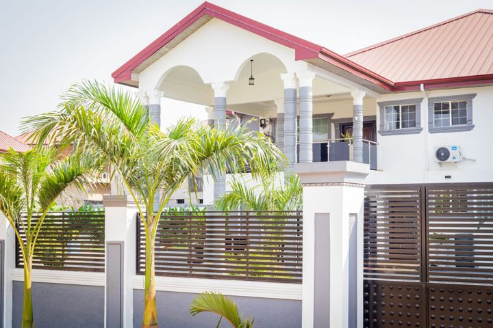 Columned front porch with royal palms
